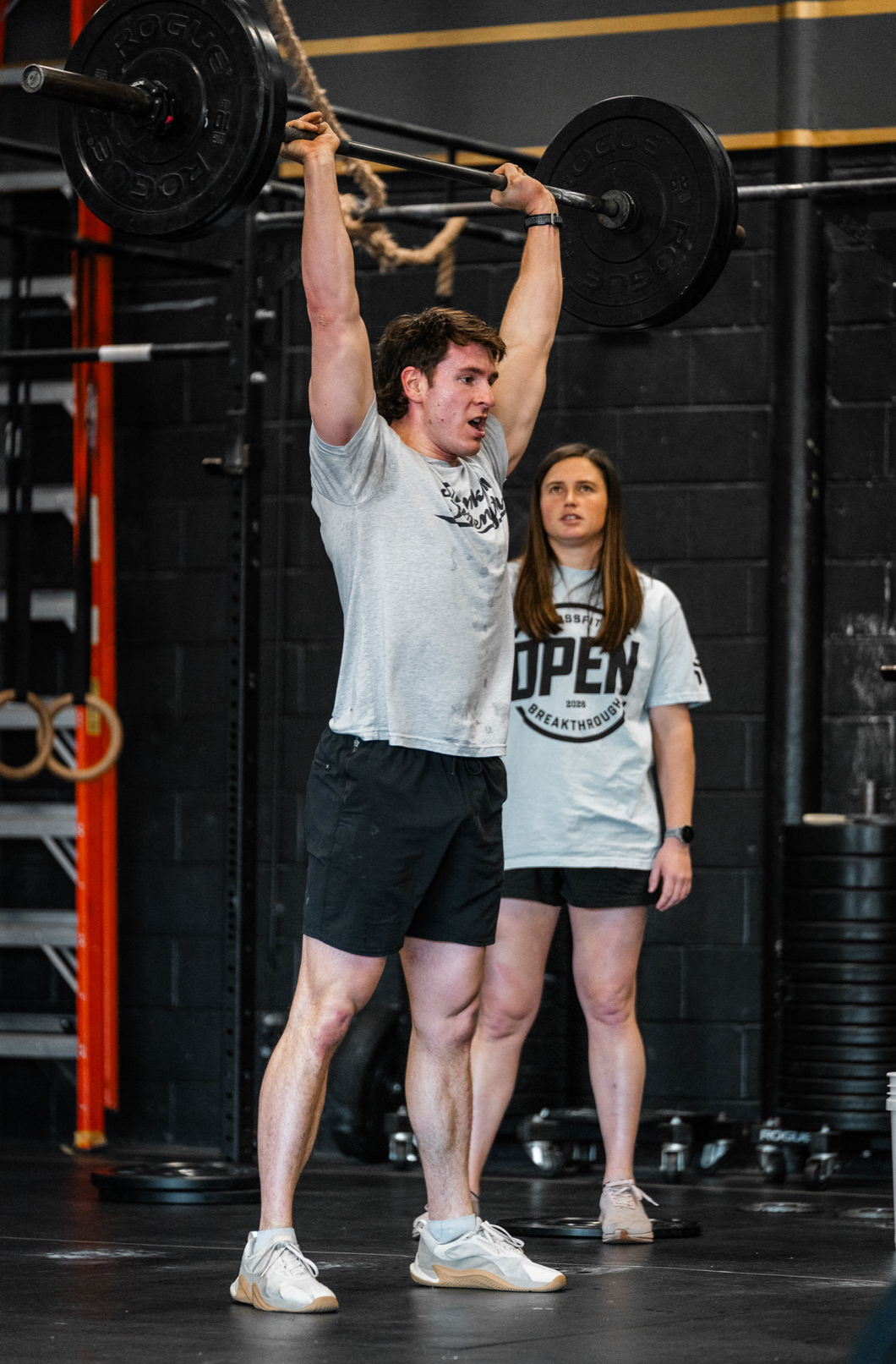 Athlete performing a barbell lift in a performance gym